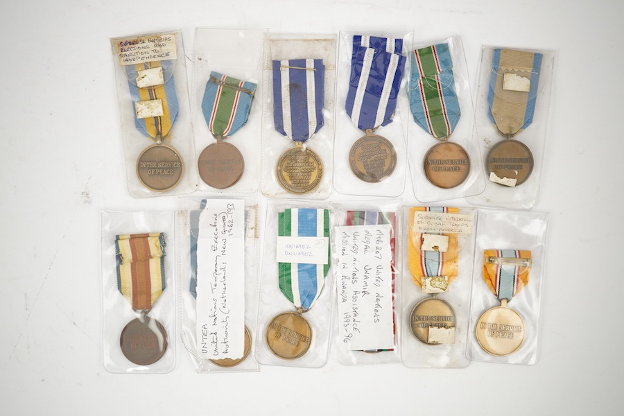 Thirteen United Nations (UN) and NATO medals, eleven UN examples with ‘ in the service of peace’ to the reverse, including a variety of ribbons for a number of different campaigns, (some duplicates), and two NATO ISAF Af